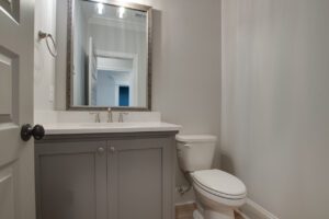 A beautiful toilet with mirror and washing basin