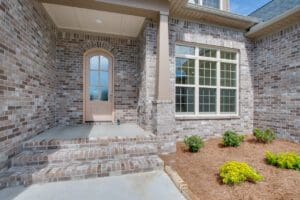 Brick house with a front porch and steps.